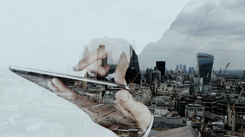 Double exposure of businessman working with new modern computer and london city background as concept