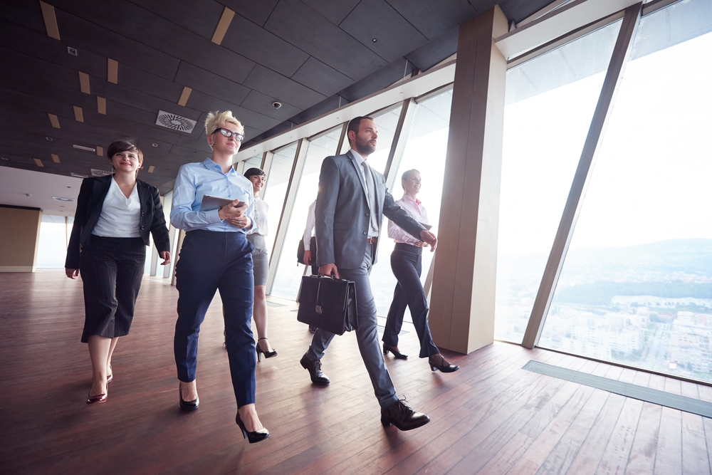 business team, businesspeople  group walking at modern bright office interior